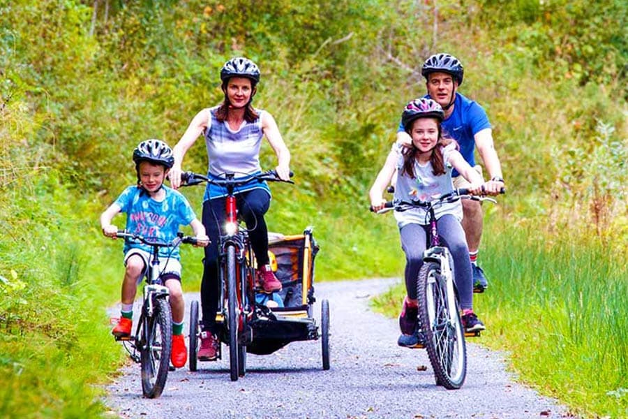 Family cycling on canal side path